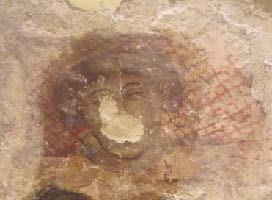 Pintura mural amb el rostre molt esvaït abans de la restauració